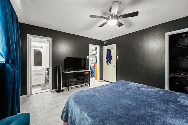 bedroom featuring connected bathroom, ceiling fan, a closet, and a spacious closet