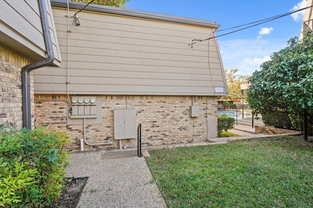 view of side of home featuring a yard