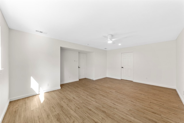 spare room with light wood-type flooring and ceiling fan