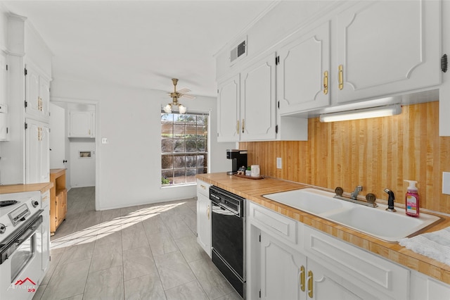 kitchen featuring ceiling fan, sink, white electric range, black dishwasher, and white cabinets