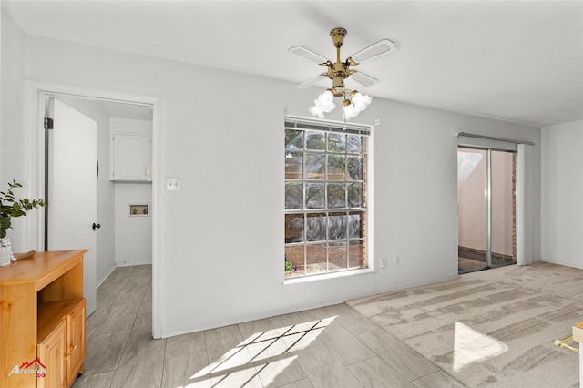 unfurnished dining area featuring ceiling fan