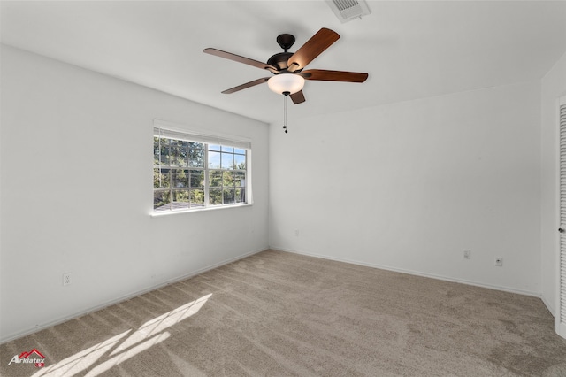 unfurnished room featuring light carpet and ceiling fan