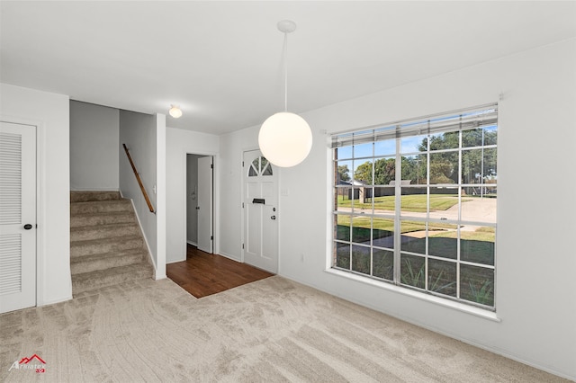 view of carpeted foyer entrance