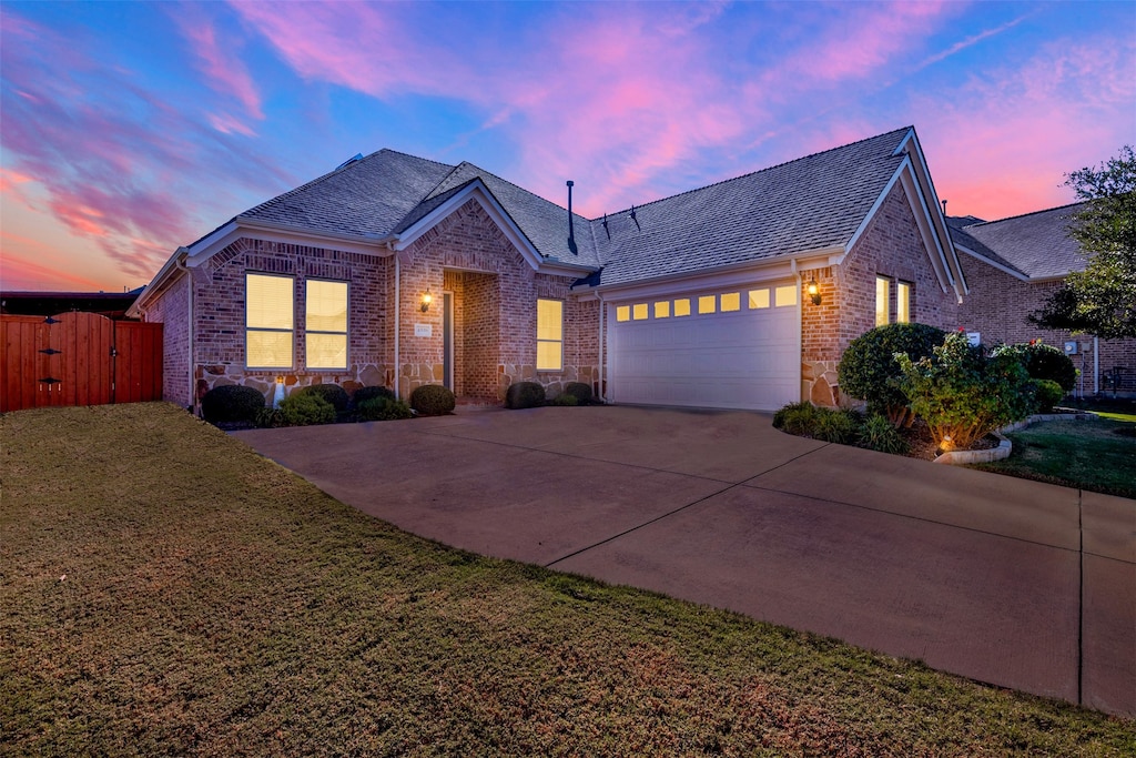 view of front of property with a lawn and a garage