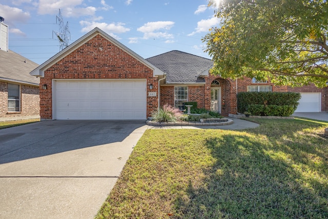 view of front of home with a front yard and a garage