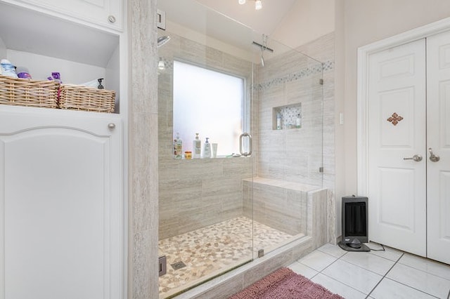 bathroom featuring tile patterned flooring, an enclosed shower, and lofted ceiling