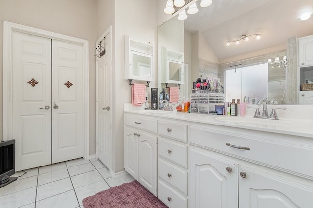 bathroom with vanity, tile patterned floors, and lofted ceiling