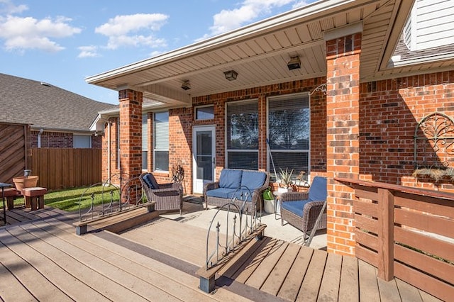 wooden deck with an outdoor living space