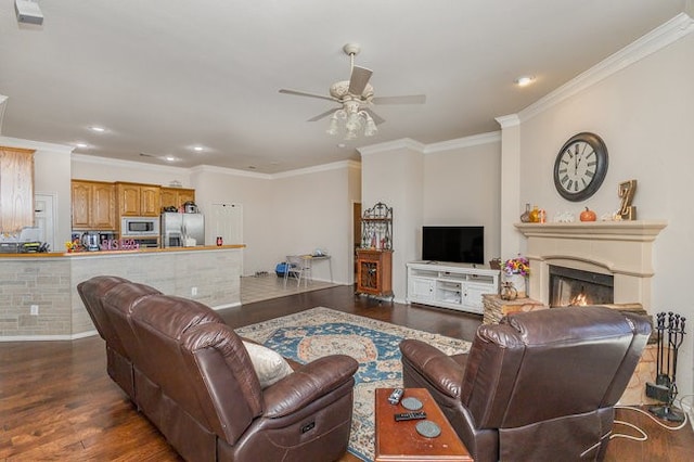 living room with hardwood / wood-style floors, ceiling fan, and crown molding