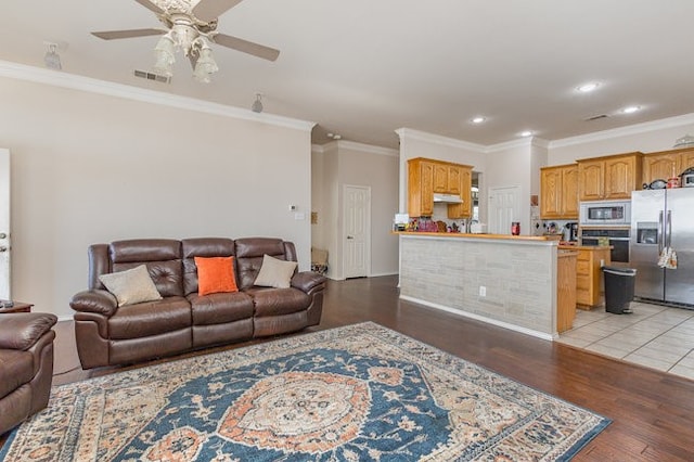 living room featuring ceiling fan, light hardwood / wood-style flooring, and ornamental molding