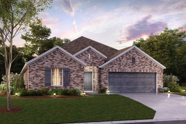 view of front facade with a yard and a garage