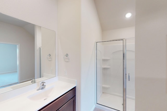 full bath with vaulted ceiling, a stall shower, and vanity