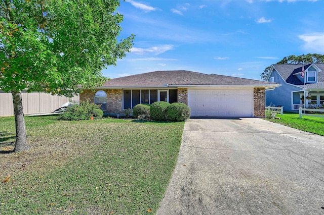 ranch-style home with a front yard and a garage