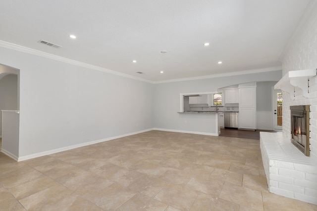 unfurnished living room featuring ornamental molding and a fireplace