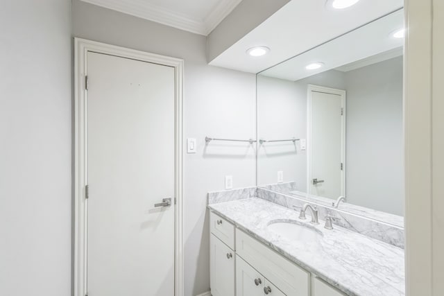 bathroom with vanity and ornamental molding