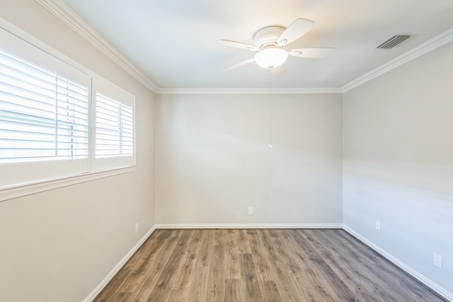 empty room with hardwood / wood-style flooring, ceiling fan, and crown molding