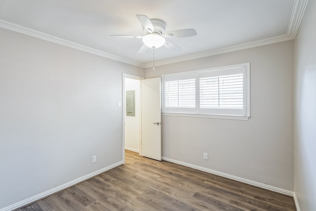 unfurnished room featuring hardwood / wood-style flooring, ceiling fan, ornamental molding, and electric panel