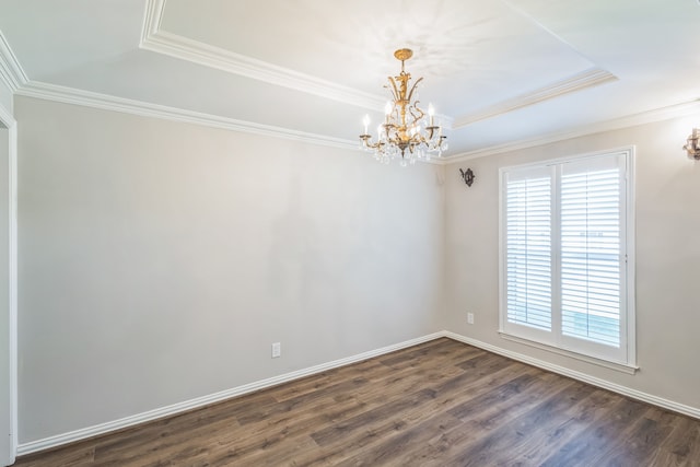 unfurnished room with a raised ceiling, crown molding, dark hardwood / wood-style flooring, and an inviting chandelier