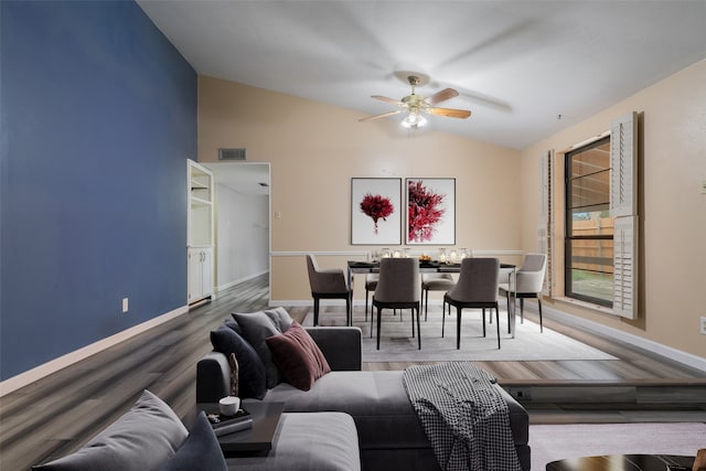 living room featuring hardwood / wood-style flooring, vaulted ceiling, and ceiling fan