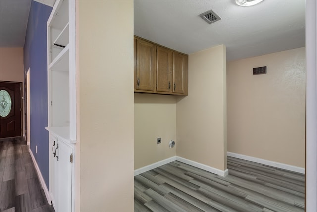 washroom with hardwood / wood-style floors and hookup for an electric dryer