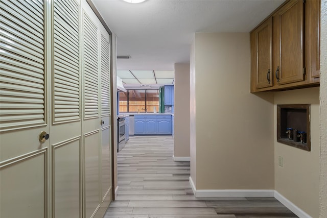 hall with light hardwood / wood-style floors