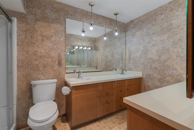 bathroom with a shower with door, vanity, and toilet