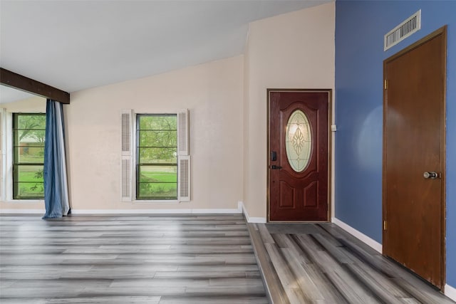 entrance foyer with vaulted ceiling with beams and dark wood-type flooring