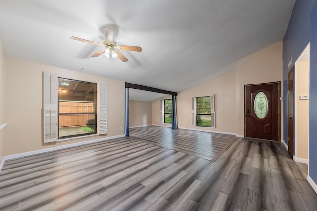 unfurnished living room with hardwood / wood-style flooring, ceiling fan, and lofted ceiling