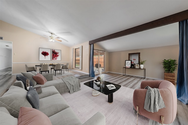 living room featuring lofted ceiling with beams, light hardwood / wood-style flooring, and ceiling fan