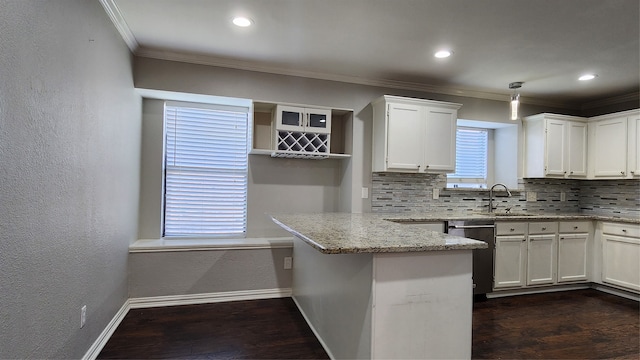 kitchen with light stone countertops, dark wood-type flooring, kitchen peninsula, decorative backsplash, and white cabinets