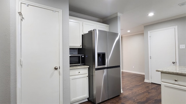 kitchen featuring white cabinets, dark hardwood / wood-style floors, light stone countertops, ornamental molding, and stainless steel appliances