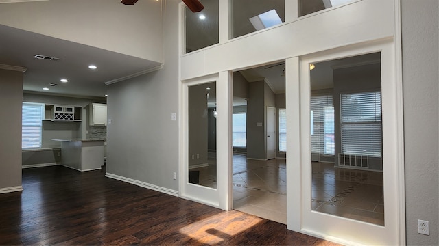 spare room with ceiling fan, dark hardwood / wood-style flooring, and ornamental molding