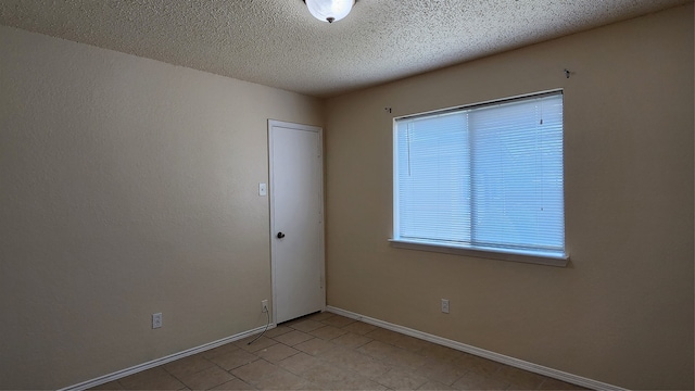 empty room with a textured ceiling