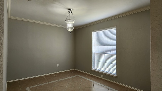 tiled spare room featuring crown molding