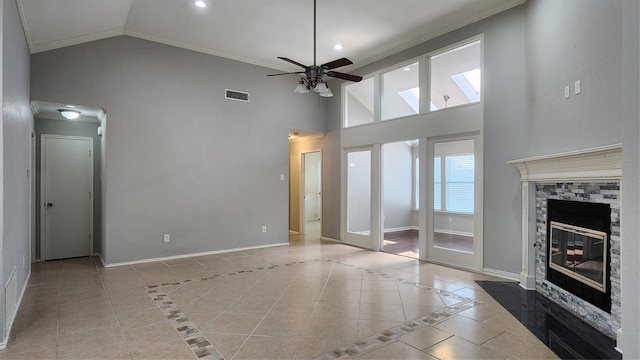 unfurnished living room featuring a fireplace, light tile patterned floors, high vaulted ceiling, and ceiling fan