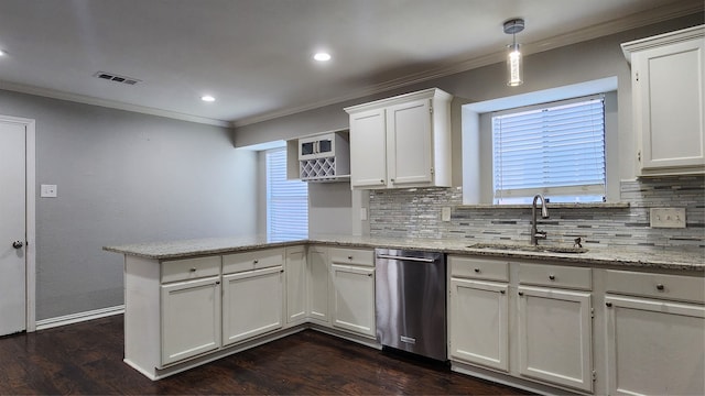 kitchen with stainless steel dishwasher, decorative light fixtures, white cabinets, and sink