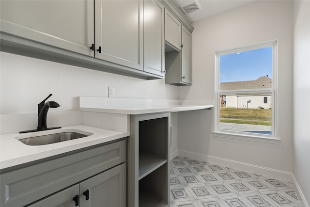 kitchen featuring gray cabinetry and sink