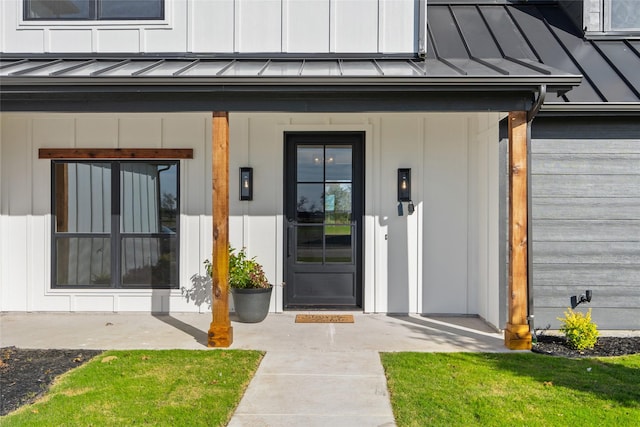 view of exterior entry featuring covered porch