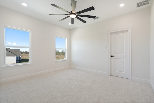 carpeted empty room featuring ceiling fan