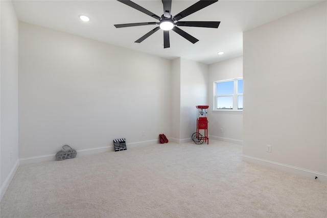 unfurnished room featuring light carpet and ceiling fan