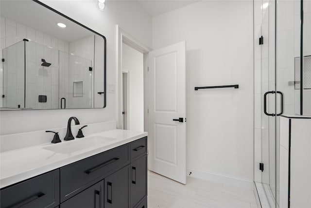 bathroom featuring vanity and an enclosed shower