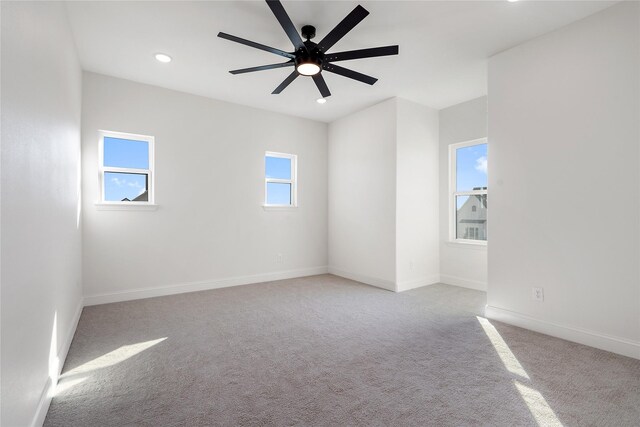 spare room with light carpet and ceiling fan