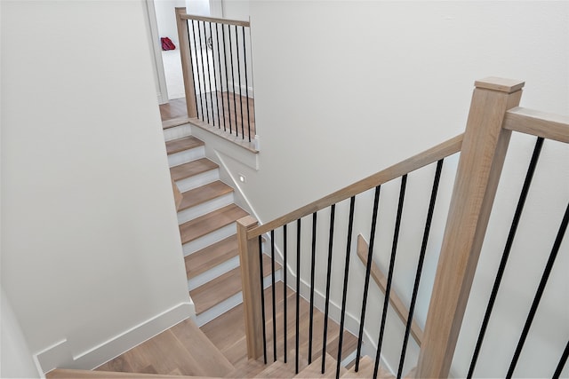 stairs featuring hardwood / wood-style floors