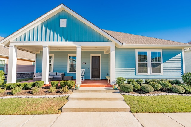 view of front of property with an outdoor living space and a porch