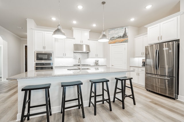 kitchen with stainless steel appliances, white cabinetry, hanging light fixtures, and a center island with sink