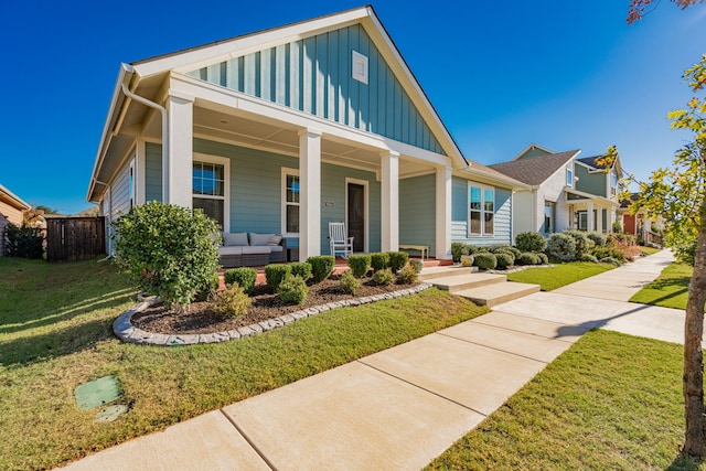 view of front of home with a porch and a front yard