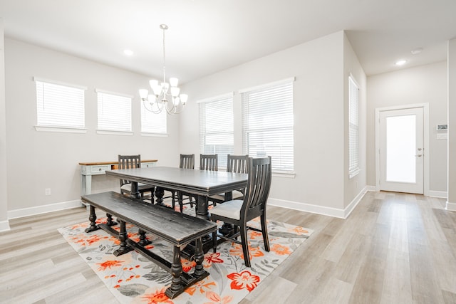 dining room with an inviting chandelier and light wood-type flooring