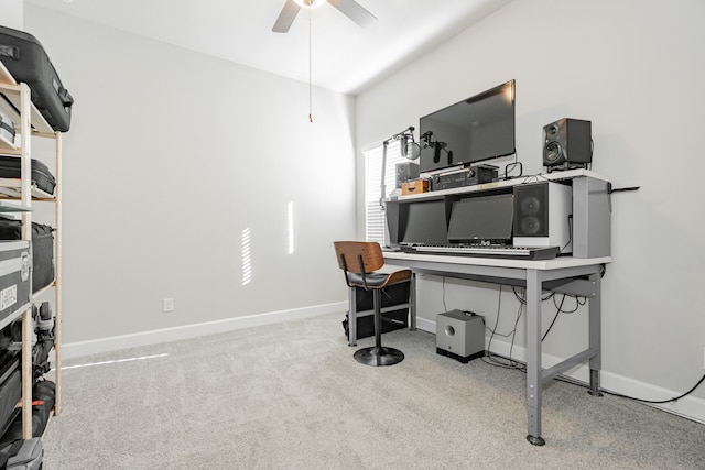 carpeted office featuring ceiling fan