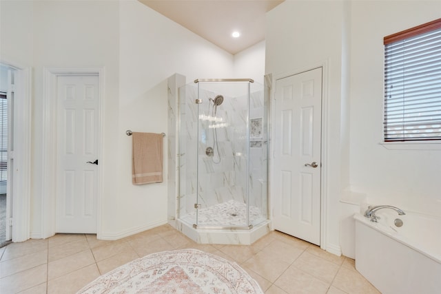 bathroom with separate shower and tub and tile patterned floors