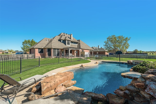 view of swimming pool featuring a lawn, a patio area, and an in ground hot tub